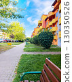 Bright residential building in a Polish city with yellow and orange balconies under a clear blue sky 130350526