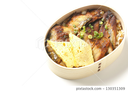 Eel bowl bento in a bento box photographed against a white background 130351309