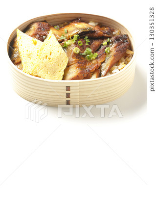 Eel bowl bento in a bento box photographed against a white background Eel bowl bento in a bento box photographed against a white background 130351328