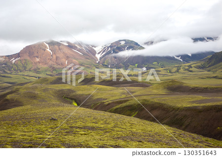 Explore the stunning landscapes of Iceland's highlands with rolling hills and mountains 130351643