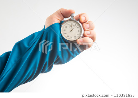 Hand holding stopwatch to measure time during a sporting event or training session Hand holding stopwatch to measure time during a sporting event or training session 130351653