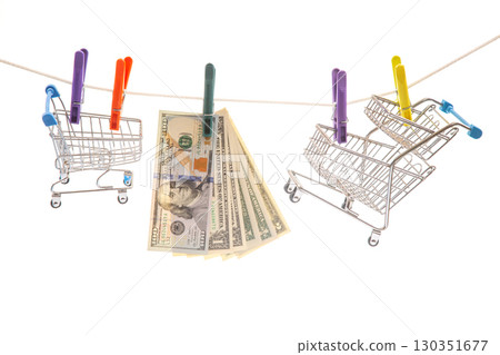 Mini shopping carts creatively hold cash and clothes pegs in a playful display 130351677