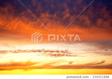 Breathtaking sunset with vibrant colors over a calm horizon near the ocean Breathtaking sunset with vibrant colors over a calm horizon near the ocean 130351886
