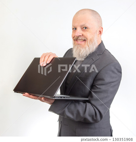 Business pro highlights laptop in studio, smiling and engaging with viewers Business pro highlights laptop in studio, smiling and engaging with viewers 130351908