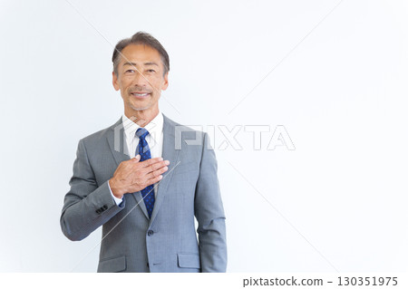 Senior businessman with his hand on his chest Senior businessman with his hand on his chest 130351975