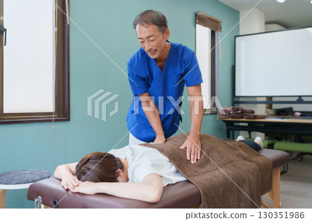 Osteopathic doctor and patient 130351986