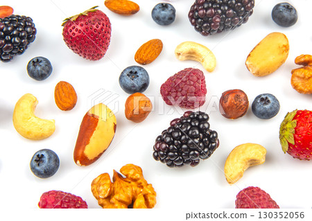 Colorful assortment of fresh berries and nuts arranged on a white background Colorful assortment of fresh berries and nuts arranged on a white background 130352056
