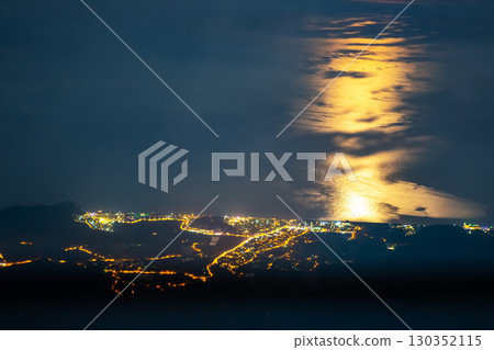 View of illuminated coastal city under moonlit sky in Turkey at night 130352115