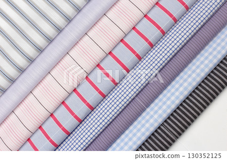 Variety of striped fabrics displayed in bright colors and patterns for fashion design 130352125