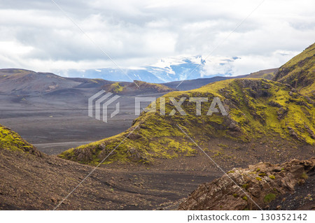 Stunning landscape of moss-covered hills and rugged terrain in Iceland's volcanic region 130352142