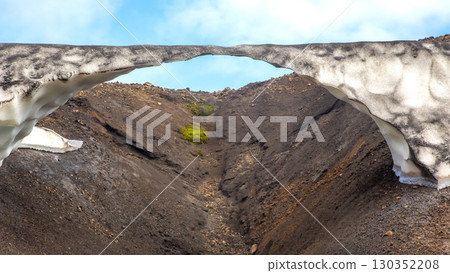 Beautiful snow arch in Iceland's rugged landscape showcasing natural wonders and geology Beautiful snow arch in Iceland's rugged landscape showcasing natural wonders and geology 130352208