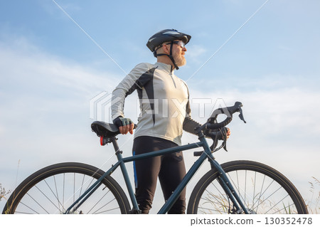 Cyclist enjoying fresh air and scenery during outdoor ride on a clear day 130352478