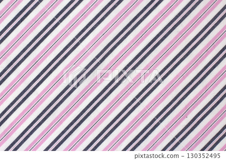 Colorful striped fabric design featuring pink, white, and navy blue hues in a textile pattern 130352495