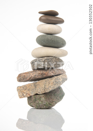 Balanced stone tower showcasing natural textures in serene indoor setting Balanced stone tower showcasing natural textures in serene indoor setting 130352502