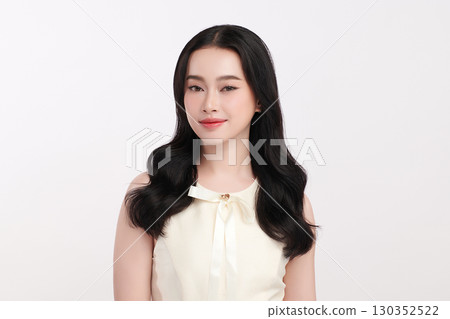A beautiful young Asian woman with clean, fresh skin against a white background. Skincare, facial treatment, cosmetology, beauty, and spa. An elegant portrait of an Asian woman. 130352522