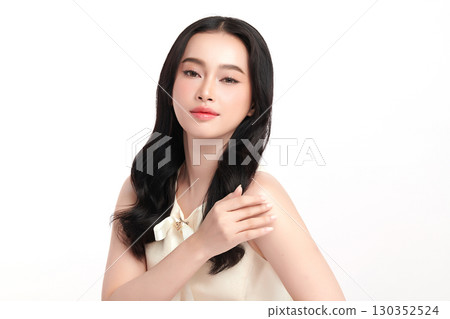 A beautiful young Asian woman with clean, fresh skin against a white background. Skincare, facial treatment, cosmetology, beauty, and spa. An elegant portrait of an Asian woman. A beautiful young Asian woman with clean, fresh skin against a white background. Skincare, facial treatment, cosmetology, beauty, and spa. An elegant portrait of an Asian woman. 130352524