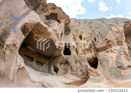 Explore the fascinating rock formations and ancient cave dwellings found in Cappadocia, Turkey 130352615