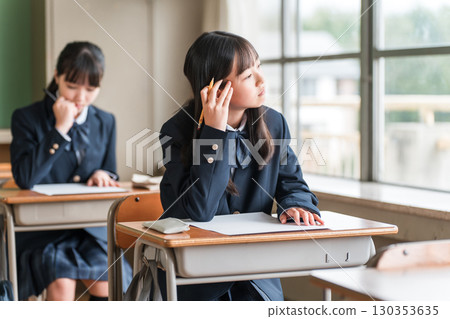 Female elementary, junior high, and high school students looking unmotivated outside during a test (apathetic, rebellious, sulky) Female elementary, junior high, and high school students looking unmotivated outside during a test (apathetic, rebellious, sulky) 130353635