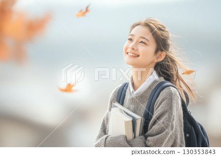 Autumn portrait of a high school girl working hard for exams and tests 130353843