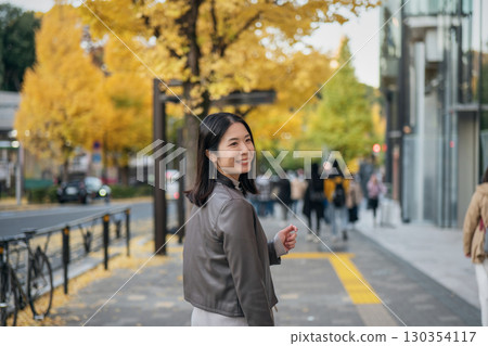 A woman walking down the autumn street 130354117