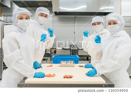 Male and female staff working in food processing wearing sanitary clothing (food hygiene, food factory, hygiene management) 130354950