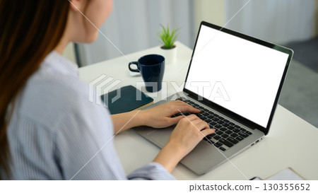 Female hands typing on computer keyboard with copy space screen for design 130355652