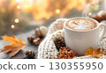 Autumn Morning Warmth: Relaxing in the sunlight with a warm latte and a knitted sweater 130355950