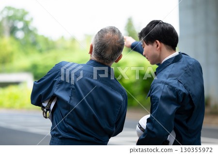 Young and veteran workers in work clothes Young and veteran workers in work clothes 130355972