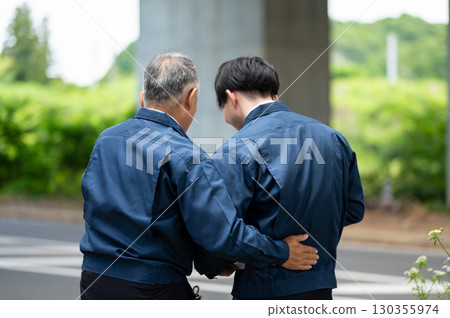 Young and veteran workers in work clothes Young and veteran workers in work clothes 130355974