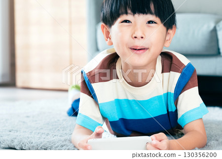 Boy playing with a smartphone 130356200