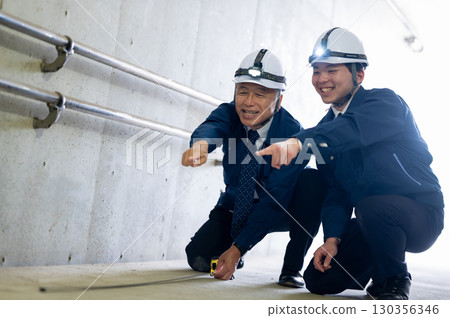 Veterans and young workers at work 130356346