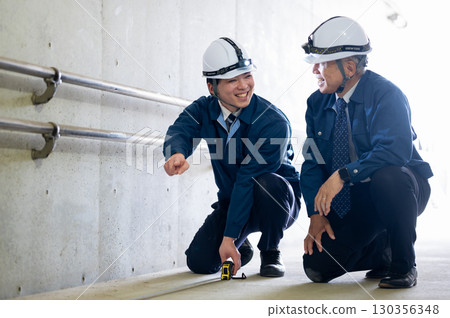 Veterans and young workers at work 130356348