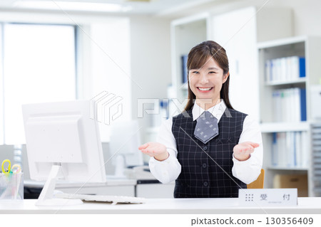 Portrait of a business woman at the reception desk 130356409