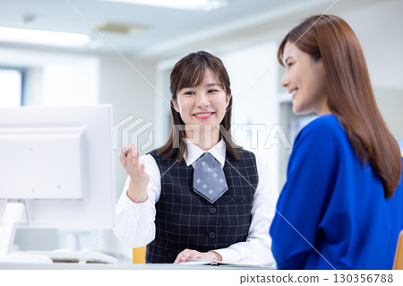 Business woman serving customers at the counter 130356788