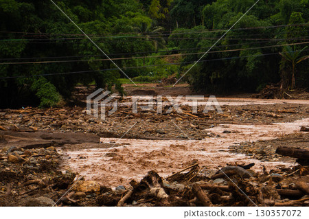 Flood Aftermath with Muddy Water and Debris Blocking Rural Area Flood Aftermath with Muddy Water and Debris Blocking Rural Area 130357072