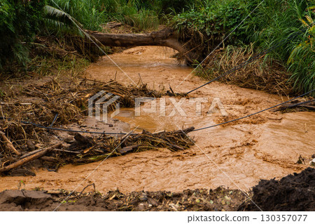 Flood Aftermath with Muddy Water and Debris Blocking Rural Area Flood Aftermath with Muddy Water and Debris Blocking Rural Area 130357077