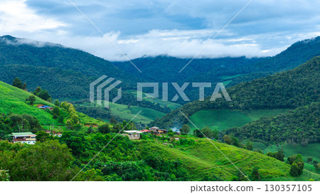 Mountain Village with Green Hills and Clouds 130357105