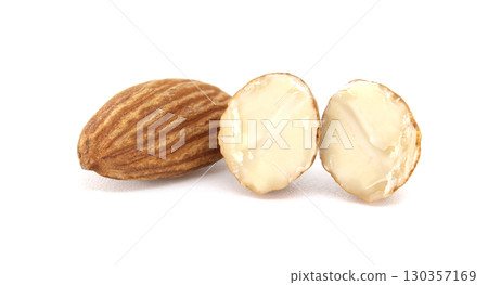 A detailed view of almonds, with a whole one and two cut-open halves against a white background. A detailed view of almonds, with a whole one and two cut-open halves against a white background. 130357169