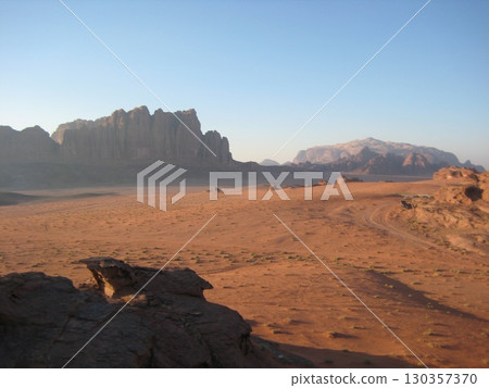 Wadi Rum desert and rocky mountains at sunset 130357370