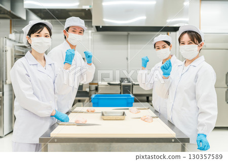 Male and female staff in chef coats preparing chicken (chef, chef, fresh market, food processing) Male and female staff in chef coats preparing chicken (chef, chef, fresh market, food processing) 130357589