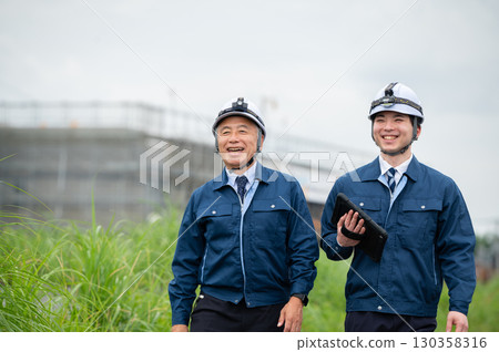 Young and veteran construction workers 130358316