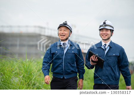 Young and veteran construction workers 130358317