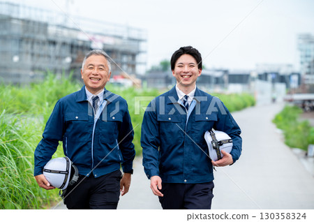 Young and veteran construction workers Young and veteran construction workers 130358324