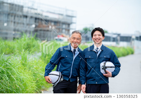 Young and veteran construction workers 130358325