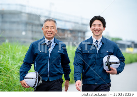 Young and veteran construction workers 130358329