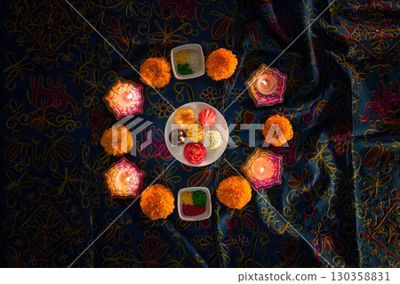 Diwali festival sweets and flowers arranged in a circular pattern Diwali festival sweets and flowers arranged in a circular pattern 130358831