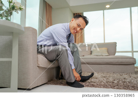 A Confident Young Man Who is Preparing Himself in a Modern Apartment Space A Confident Young Man Who is Preparing Himself in a Modern Apartment Space 130358965