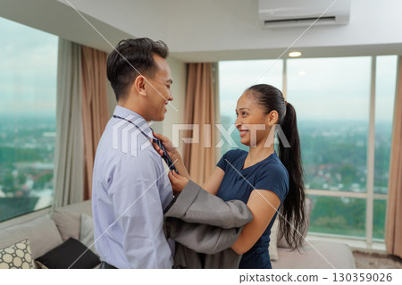 A Romantic Moment Between a Couple in Their Apartment with a City View A Romantic Moment Between a Couple in Their Apartment with a City View 130359026