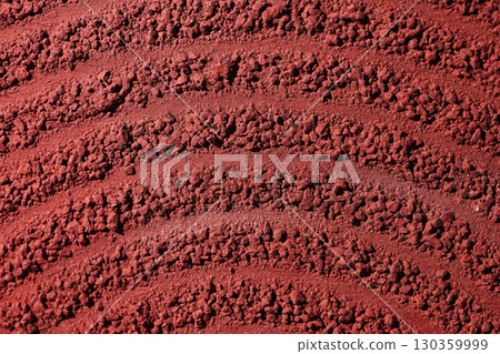 Closeup detail of showcasing the rough and textured lane lines against a red background. Textures and colors create an abstract and engaging composition. Textured background 130359999