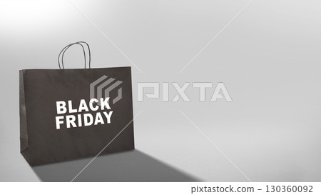 Closeup view of Black Friday text on a black shopping bag. Copy space. Flat lay. Black Friday sale concept 130360092